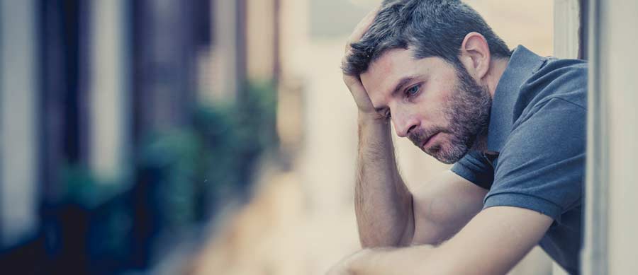 man depressed on balcony