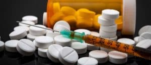 opioids pills, bottles and needles