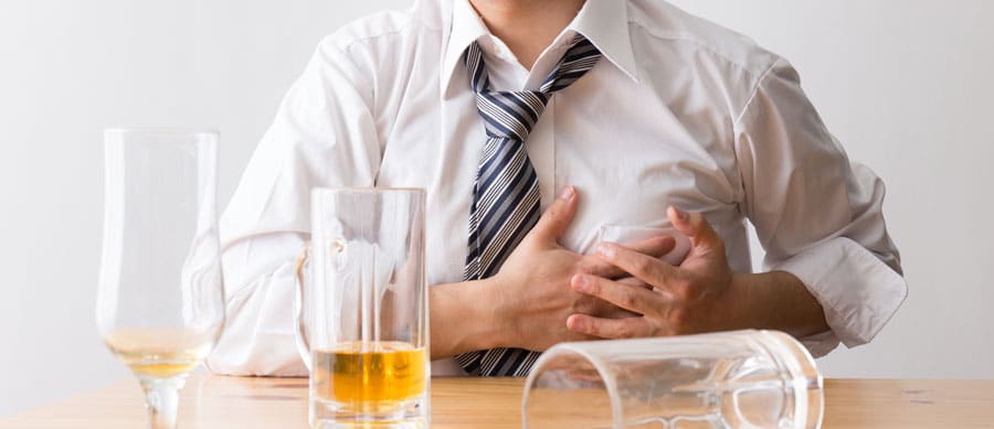 man suffers from chest pain after drinking alcohol
