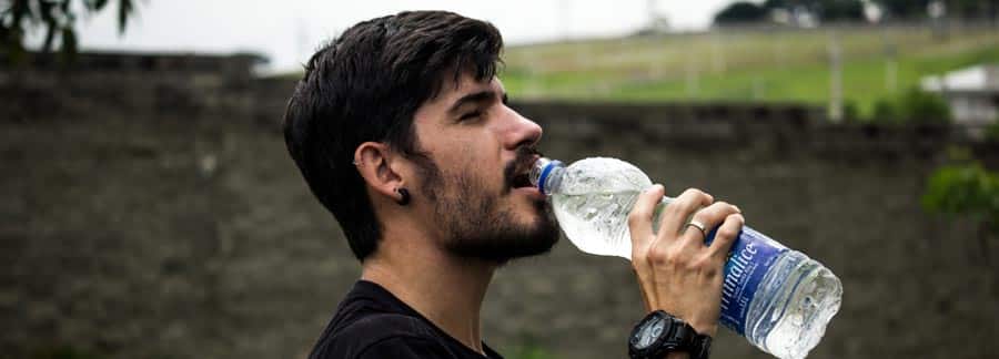 man drinks water after detoxing from alcohol