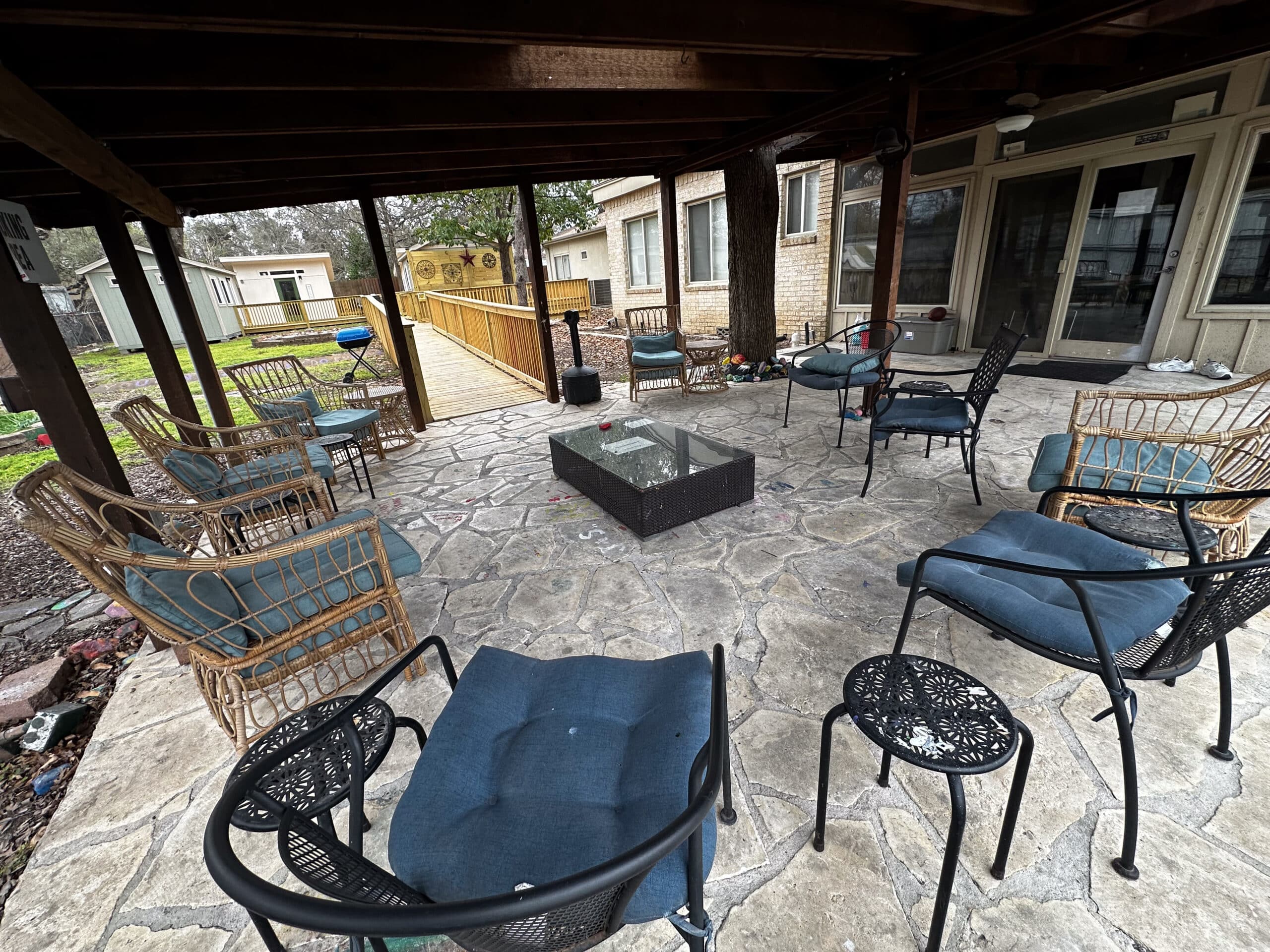Covered outdoor patio at Briarwood Detox Center Austin with seating and fire pit.