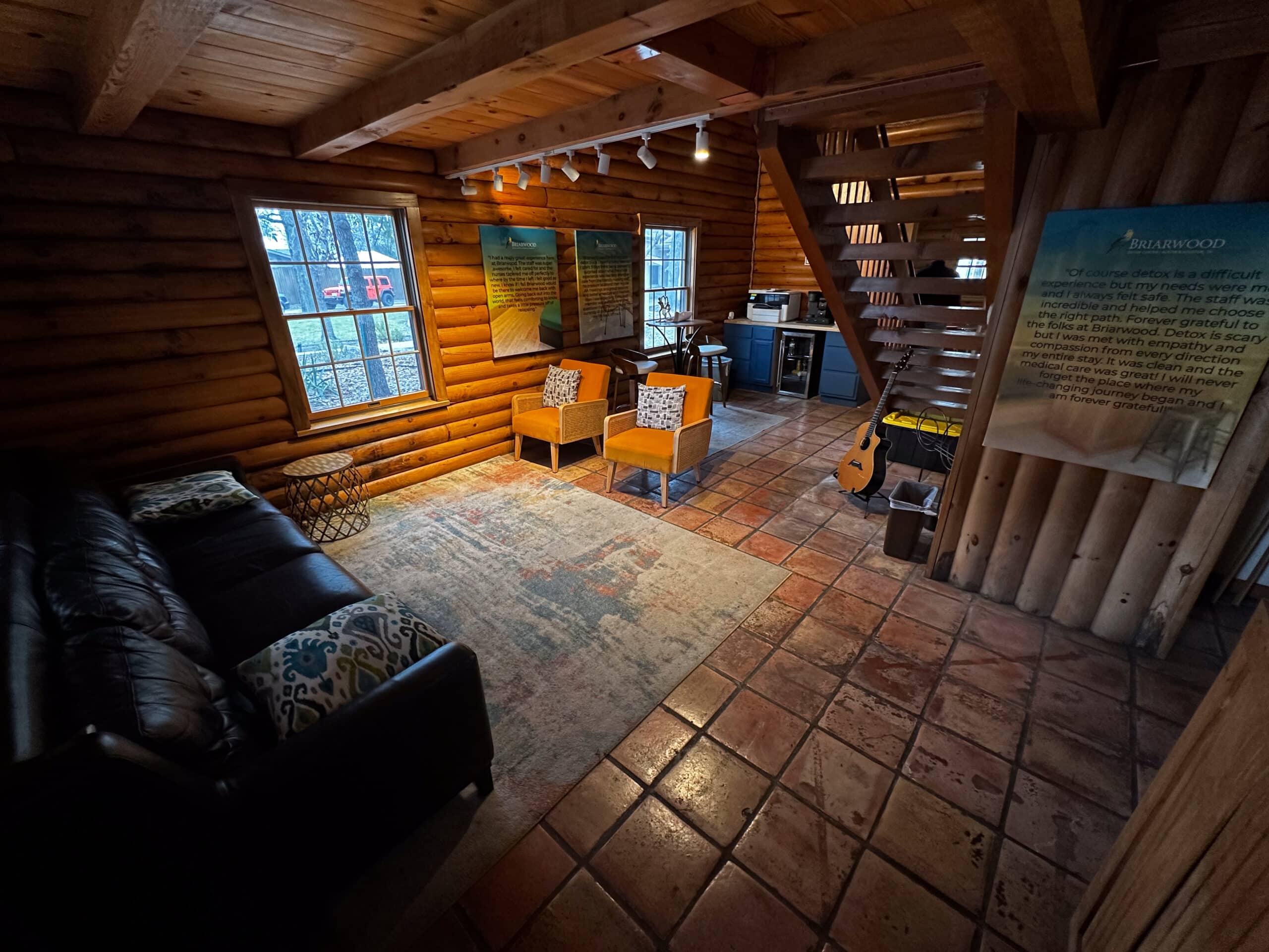 Interior view of log cabin common area at Briarwood Detox Center Austin with rustic furniture.