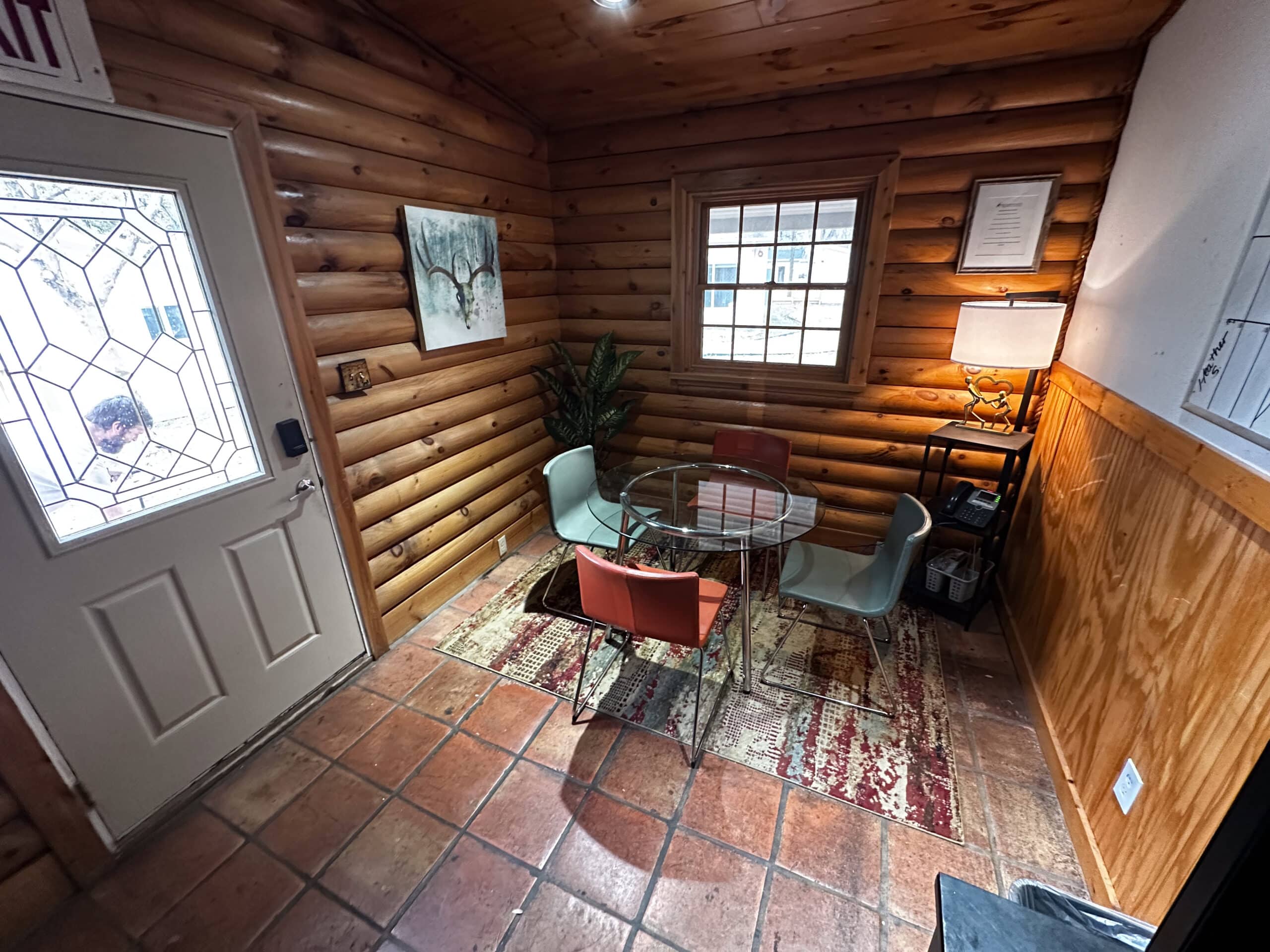 Consultation room near entrance of Briarwood Detox Center Austin with round glass table and chairs.