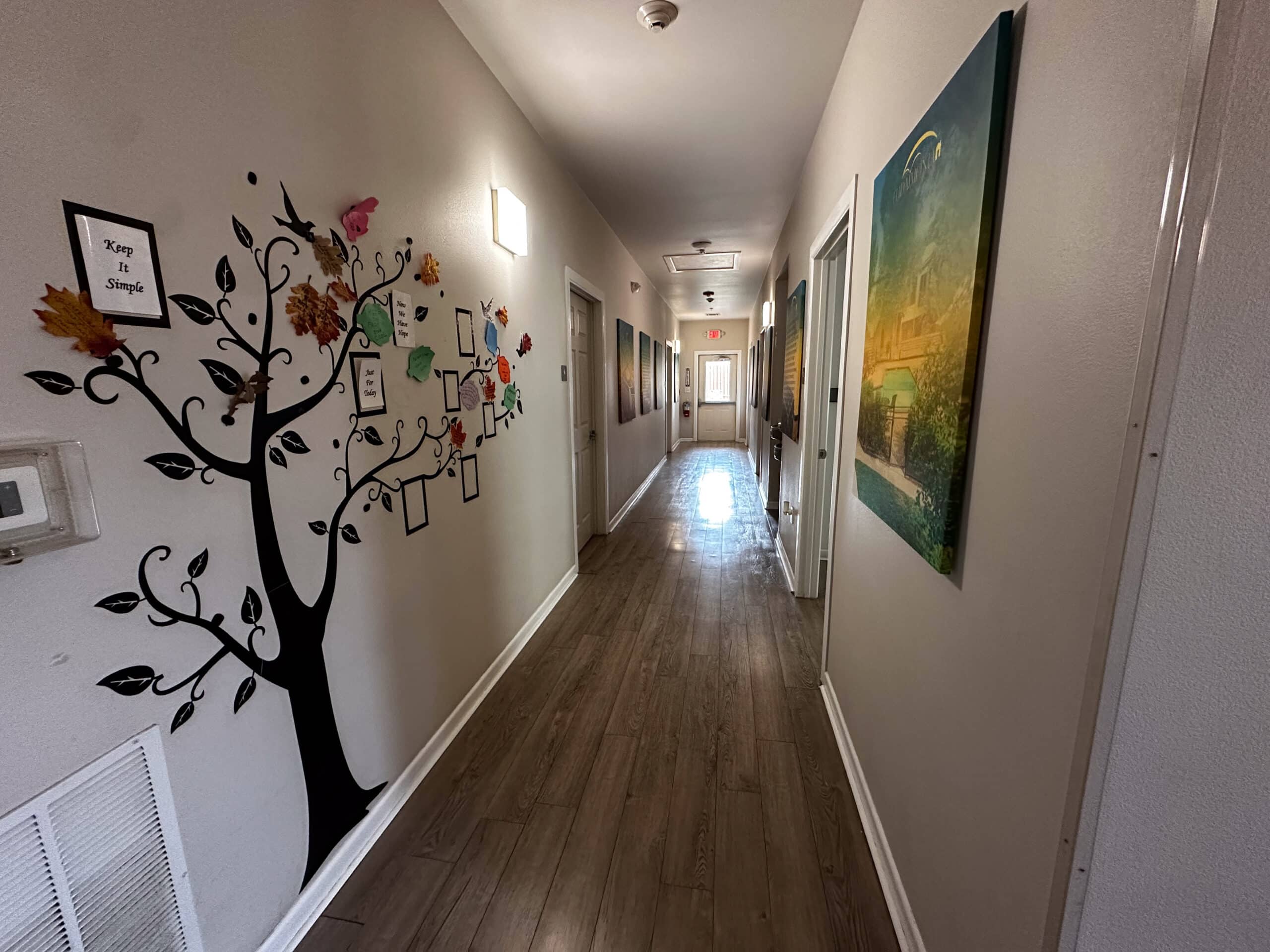 Motivational art and recovery tree mural in hallway at Briarwood Detox Center Austin.