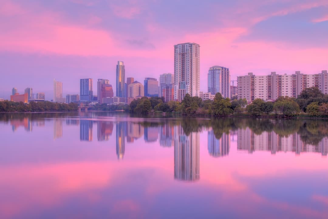 a city skyline with a body of water in front of it -- Photo by Cody McLain on Unsplash