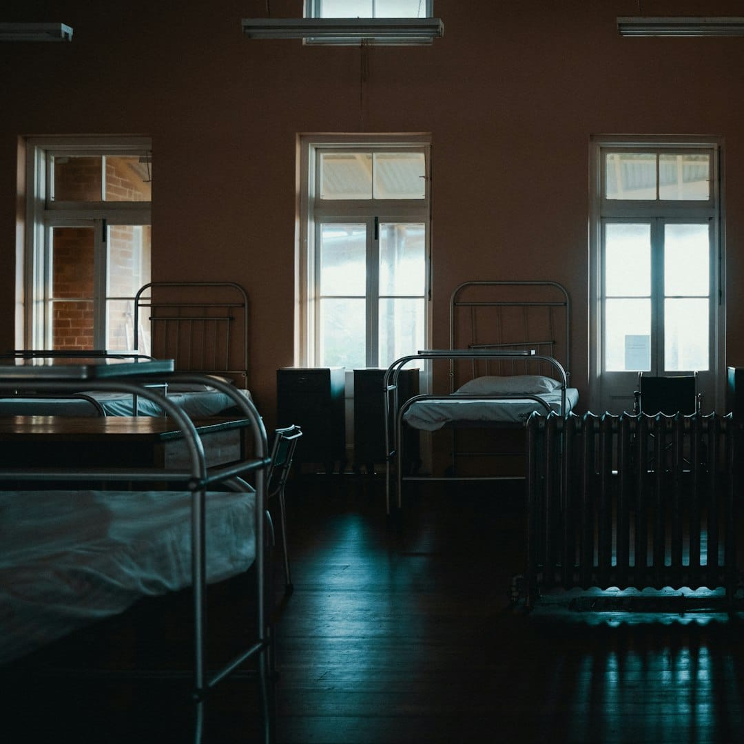 empty beds inside room -- Photo by Gilberto Olimpio on Unsplash