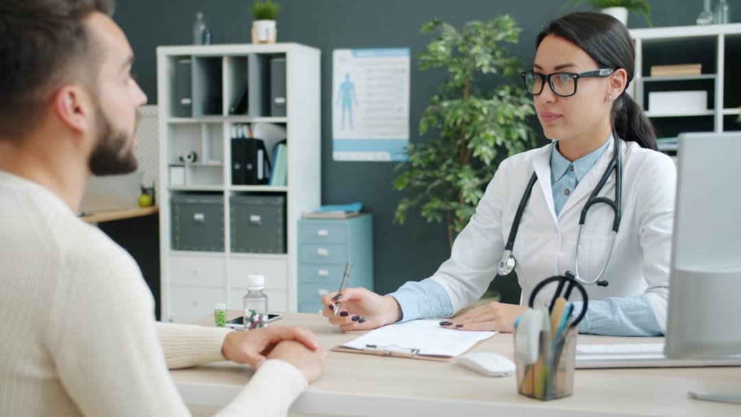 Doctor consulting with a patient in an office. -- Photo by Vitaly Gariev on Unsplash