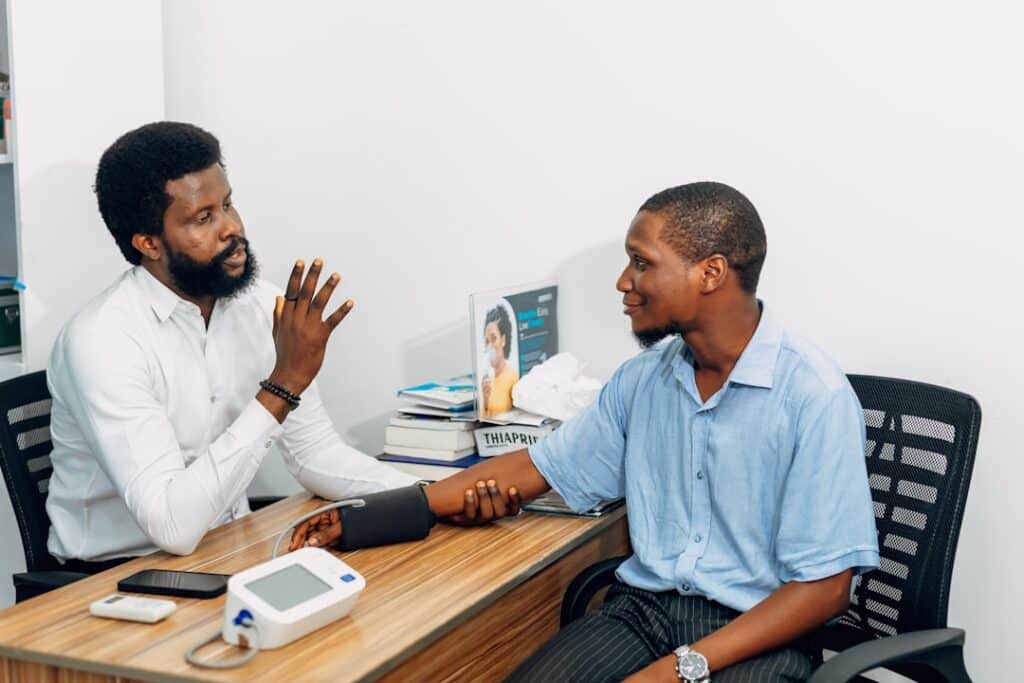 Two men sitting at a desk talking to each other -- Photo by Ninthgrid on Unsplash