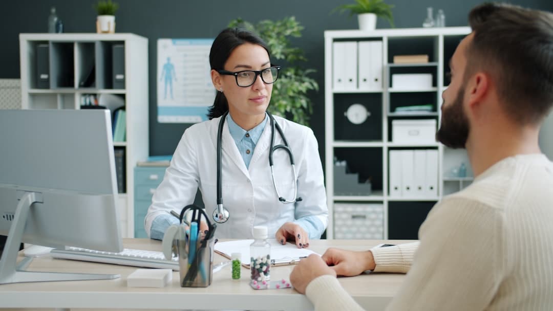 Doctor consults with patient in medical office. -- Photo by Vitaly Gariev on Unsplash
