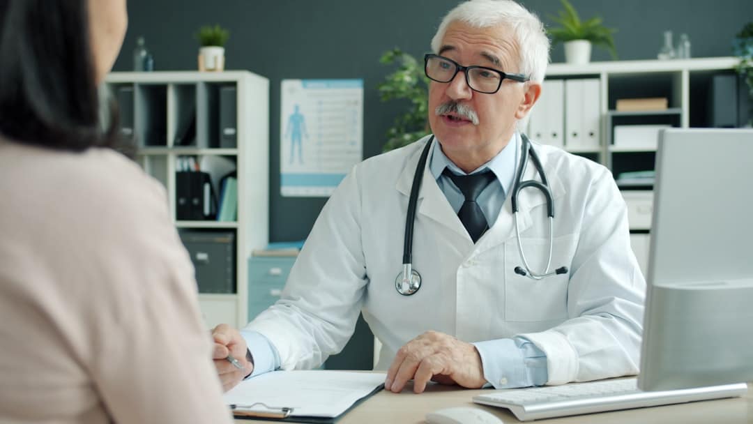 Doctor talking to patient in an office. -- Photo by Vitaly Gariev on Unsplash