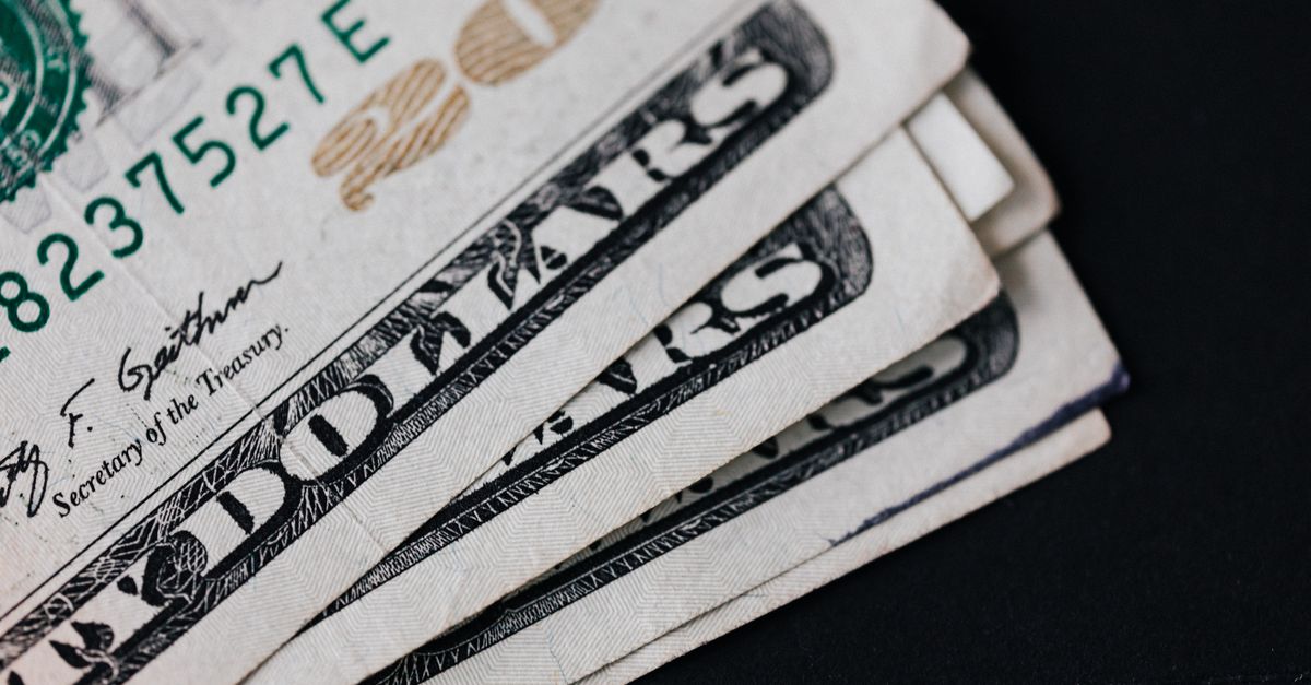 Closeup of USA 20 dollar banknotes placed on black background as national currency for business and personal financial operations