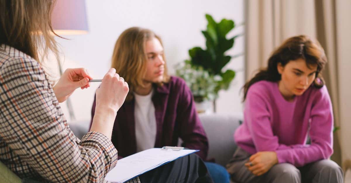 A couple receiving professional therapy in a calming indoor setting.